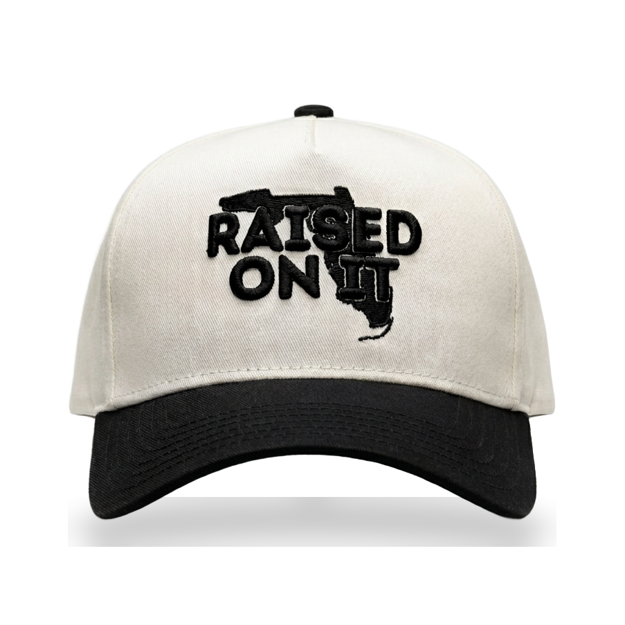 Raised On It Florida Logo embroidered trucker hat in White/Black — canvas white crown, black bill, black Florida logo stitch