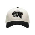Raised On It Florida Logo embroidered trucker hat in White/Black, canvas white crown, black bill, black Florida logo stitch